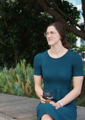 Hazel Ouwehand enjoying a coffee sitting on a bench